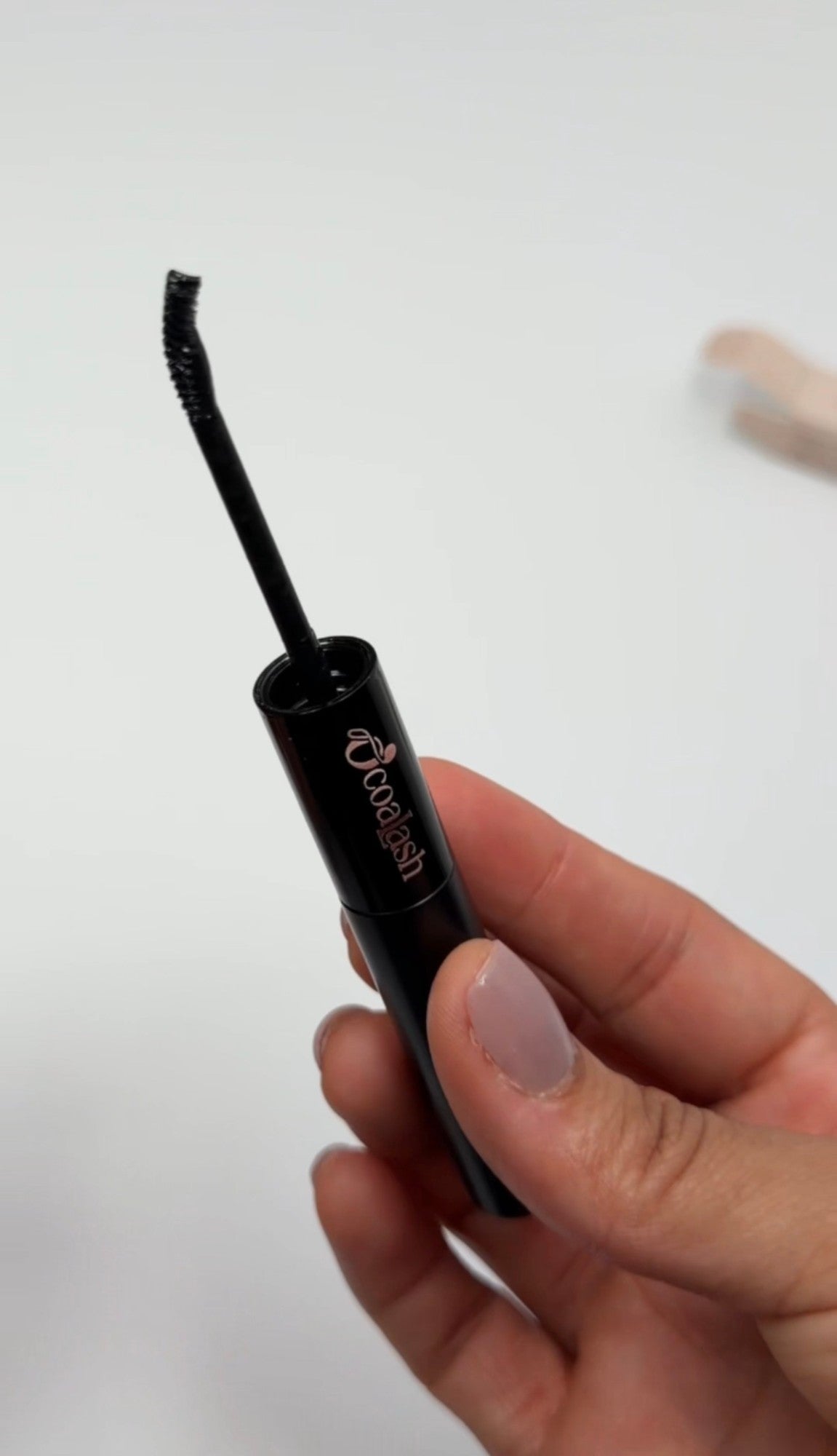 O'coalash Sealer applicator wand held in hand